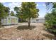 Backyard view with a large tree, shed, and home in the background at 2831 Fifer Dr, Deltona, FL 32738