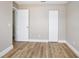 Light-filled bedroom featuring wood-look flooring, baseboard trim, a closet, and a doorway at 2831 Fifer Dr, Deltona, FL 32738