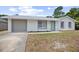 Charming single-story home with a gray garage door, white exterior, and bright blue front door at 2831 Fifer Dr, Deltona, FL 32738