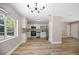 Modern kitchen and dining space showcases white cabinets, stainless steel appliances, and wood-look flooring at 2831 Fifer Dr, Deltona, FL 32738