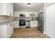 Modern kitchen featuring stainless steel appliances, granite countertops, and wood floors at 2831 Fifer Dr, Deltona, FL 32738