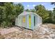 A small storage shed is located in the back yard with mature trees around it at 2831 Fifer Dr, Deltona, FL 32738