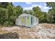 A small storage shed is located in the back yard with mature trees around it at 2831 Fifer Dr, Deltona, FL 32738
