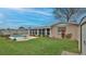 Backyard with pool, lawn, shed, sunroom, and patio with dining table at 2970 Lantern Dr, South Daytona, FL 32119