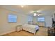 Bright bedroom featuring wood-look floors, a ceiling fan, and two dressers at 2970 Lantern Dr, South Daytona, FL 32119