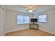 Empty bedroom featuring wood-look floors, a ceiling fan, and two windows at 2970 Lantern Dr, South Daytona, FL 32119