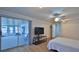 Spacious bedroom features wood floors, ceiling fan, sunroom access, and closet storage at 2970 Lantern Dr, South Daytona, FL 32119