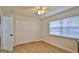 Bedroom with wood-look floors, a ceiling fan, and a window with blinds at 2970 Lantern Dr, South Daytona, FL 32119