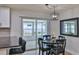Bright dining area featuring a modern light fixture and sliding door access to the screened-in patio at 2970 Lantern Dr, South Daytona, FL 32119