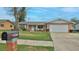Well-maintained single-story home showcasing a manicured lawn and a welcoming front entrance at 2970 Lantern Dr, South Daytona, FL 32119