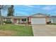 Charming single-story home featuring an attached two-car garage and a well-manicured front lawn at 2970 Lantern Dr, South Daytona, FL 32119