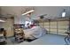 Large garage featuring storage, a covered vehicle, and workbench areas at 2970 Lantern Dr, South Daytona, FL 32119