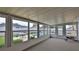 Enclosed sunroom overlooking pool and fenced yard with outdoor dining space at 2970 Lantern Dr, South Daytona, FL 32119