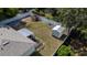 Overhead view of a large backyard, screened-in porch, shed, and lush landscaping enclosed by a white vinyl fence at 3013 Hunkin Cir, Deltona, FL 32738