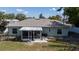 Backyard featuring a screened-in porch with seating and an outdoor grill and a garden plot at 3013 Hunkin Cir, Deltona, FL 32738