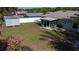 Backyard featuring a shed, screened-in porch with a seating area, and a neatly kept lawn at 3013 Hunkin Cir, Deltona, FL 32738