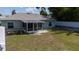 An aerial view of a backyard featuring a screened-in porch, with a sitting area, and raised garden at 3013 Hunkin Cir, Deltona, FL 32738