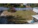 Spacious backyard featuring a lush lawn, a white vinyl fence, storage shed, and screened porch at 3013 Hunkin Cir, Deltona, FL 32738