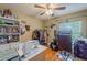 This charming bedroom offers a blend of comfort and functionality, enhanced by a ceiling fan and sewing setup at 3013 Hunkin Cir, Deltona, FL 32738