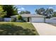 Charming home with a well-manicured front lawn and an attached two-car garage at 3013 Hunkin Cir, Deltona, FL 32738