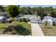 Aerial view of a one-story home with lush landscaping, a long driveway, and a two-car garage at 3013 Hunkin Cir, Deltona, FL 32738