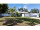 A single-Gathering home featuring a well-manicured lawn, mature landscaping, and an attached two-car garage at 3013 Hunkin Cir, Deltona, FL 32738
