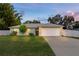 Charming one-story home featuring a well-manicured lawn, mature trees, and a spacious two-car garage at 3013 Hunkin Cir, Deltona, FL 32738