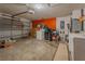 The spacious garage features ample storage and work space, including laundry hook-ups and bright lighting at 3013 Hunkin Cir, Deltona, FL 32738
