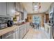 Well-lit kitchen featuring stainless steel appliances, modern cabinets, and adjacent dining area at 3013 Hunkin Cir, Deltona, FL 32738