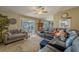 Cozy living room features tile flooring, neutral paint, and sliding door access to the backyard patio at 3013 Hunkin Cir, Deltona, FL 32738