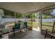 This screened porch features outdoor seating, providing a perfect spot to relax and enjoy backyard views at 3013 Hunkin Cir, Deltona, FL 32738