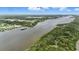 Nice aerial view of the river leading to a house with a private dock along a beautiful forested area at 317 River Front Way, Edgewater, FL 32141