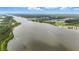 Scenic aerial shot of the river showcasing lush coastal vegetation and residential neighborhood at 317 River Front Way, Edgewater, FL 32141
