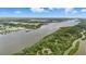 Beautiful aerial view of the river with a house with a private dock in a lovely forested area at 317 River Front Way, Edgewater, FL 32141