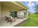 Spacious back patio with a seating area, offering an ideal outdoor living space at 317 River Front Way, Edgewater, FL 32141
