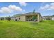 Beautiful backyard view of a covered patio and manicured lawn, perfect for outdoor activities and relaxation at 317 River Front Way, Edgewater, FL 32141