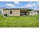 Spacious backyard featuring a covered patio and well-maintained lawn, ideal for outdoor living at 317 River Front Way, Edgewater, FL 32141