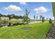 View of the tranquil pond with fountain and green lawn in this beautiful backyard at 317 River Front Way, Edgewater, FL 32141