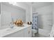 Well-lit bathroom featuring a large mirror, and a shower and tub combination at 317 River Front Way, Edgewater, FL 32141