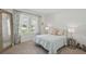 Cozy bedroom with bright windows, neutral walls, and light colored carpet at 317 River Front Way, Edgewater, FL 32141