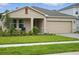 Attractive single-Gathering home featuring a front porch, two-car garage and well-kept lawn at 317 River Front Way, Edgewater, FL 32141