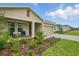 Charming single-Gathering home with a well-manicured lawn, paved driveway, and inviting front porch seating at 317 River Front Way, Edgewater, FL 32141