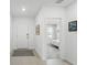 Bright hallway with ceramic tile flooring, leading to a bedroom with a view of the window at 317 River Front Way, Edgewater, FL 32141