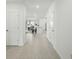 Open-concept hallway leading to the kitchen, living room, and backyard of the home at 317 River Front Way, Edgewater, FL 32141
