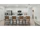 Stylish kitchen features white cabinets, stainless steel appliances, and a center island with barstool seating at 317 River Front Way, Edgewater, FL 32141