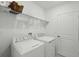 Bright laundry room with a front loading washer and dryer at 317 River Front Way, Edgewater, FL 32141