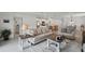 Open-concept layout of the living space with neutral furniture, leading into the kitchen and dining area at 317 River Front Way, Edgewater, FL 32141
