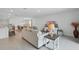 Open-concept living space with comfortable seating, seamlessly connected to the dining and kitchen areas at 317 River Front Way, Edgewater, FL 32141