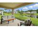 Relaxing covered patio featuring comfortable seating and a scenic view of the tranquil pond at 317 River Front Way, Edgewater, FL 32141