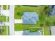 Aerial view showcasing a well-maintained home, green lawn, and landscaping, with a lake view in a residential neighborhood at 32 Abacus Ave, Ormond Beach, FL 32174